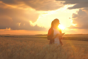 Female farmer with sunlight and storm