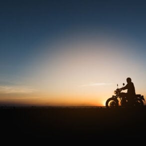 Silhouette of man on motorcycle