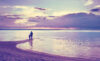 Silhouette of father and son on beach in soft light