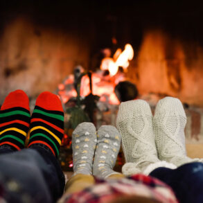 Socks on feet with fireplace