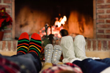 Socks on feet with fireplace