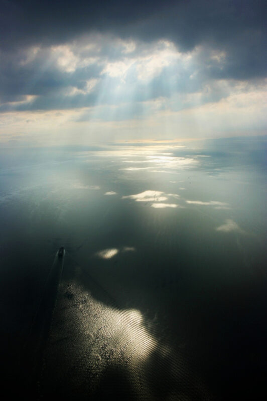 Aerial view of sunset in Manila Bay, with ship.