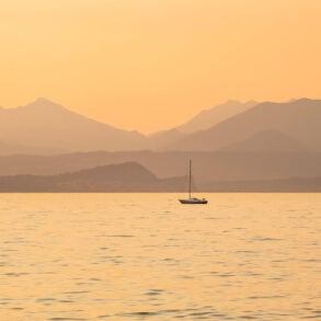 Sailboat on sea in orange light