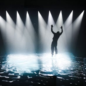 Silhouette of person on stage with water