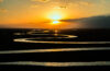 Winding river reflected in sunset