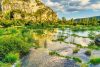Grassy river with cliffs