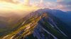Mountains in golden light with clouds