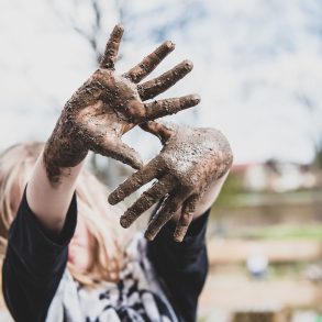 Girl with muddy hands