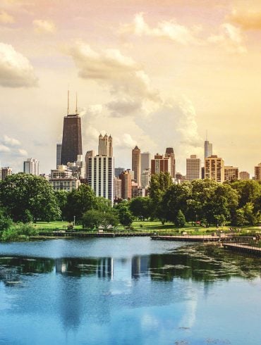 Chicago skyline viewed from park with lake in afternoon light