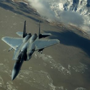 F-15 Eagle fighter jet over barren mountains