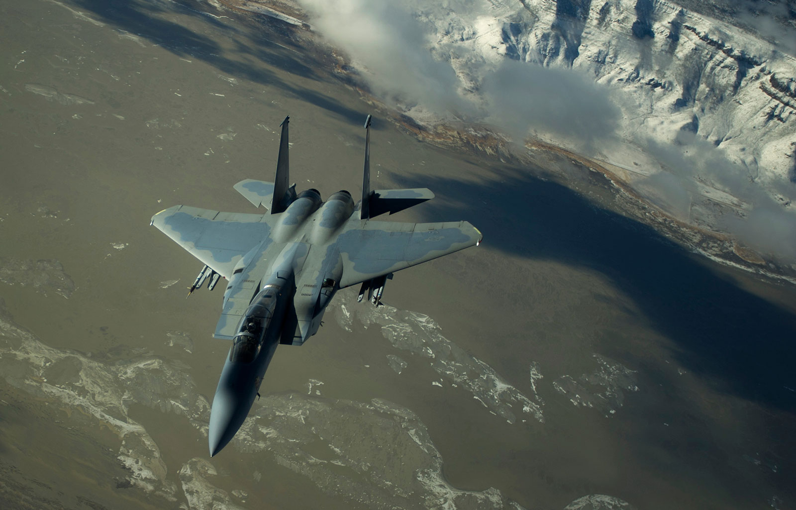F-15 Eagle fighter jet over barren mountains