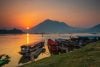 Mekong River sunrise with skiffs and ferry boat