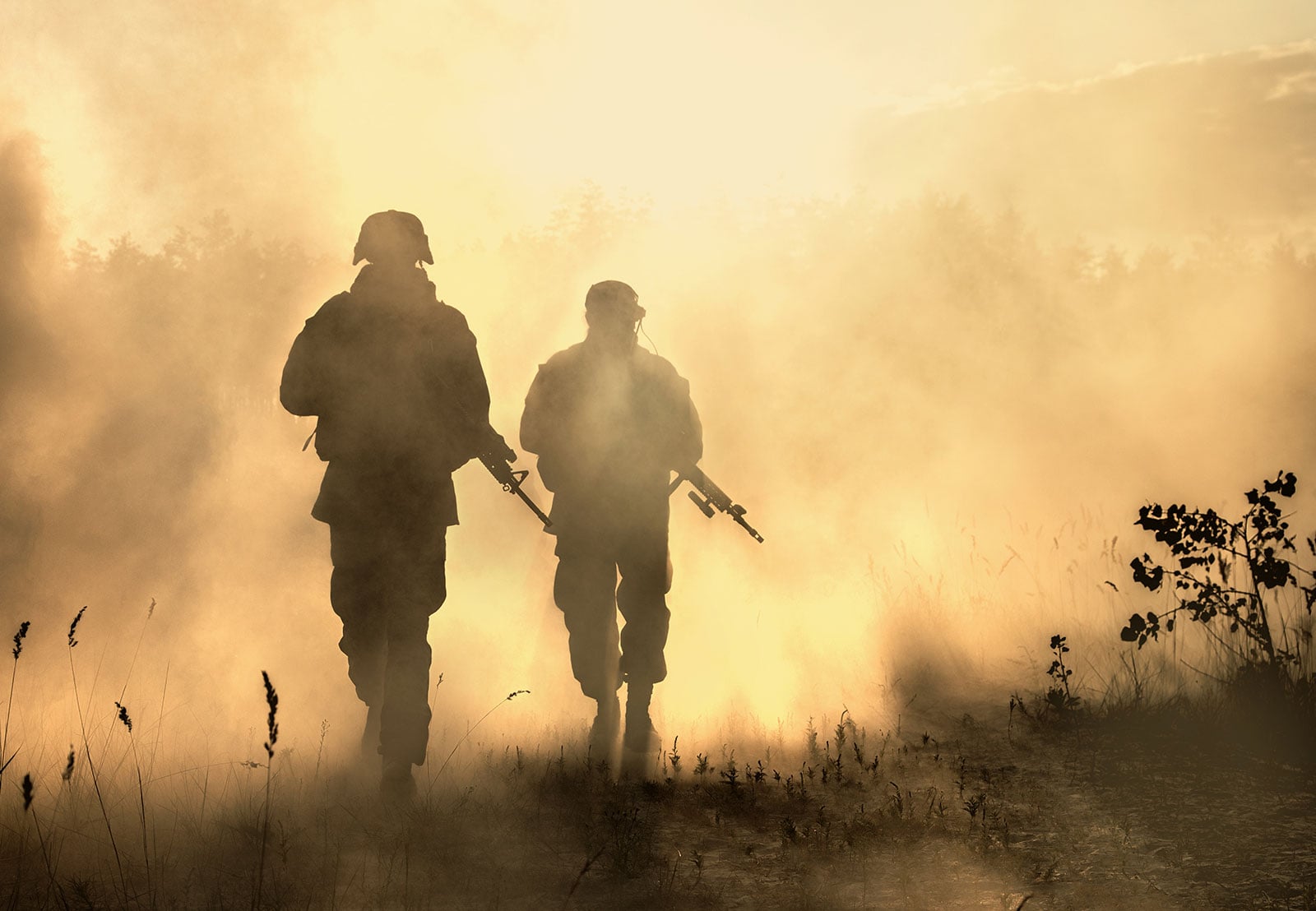 Soldiers walking through smoky field