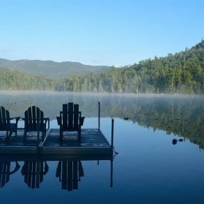 Adirondacks: lake, mountains, forest, and dock with chairs